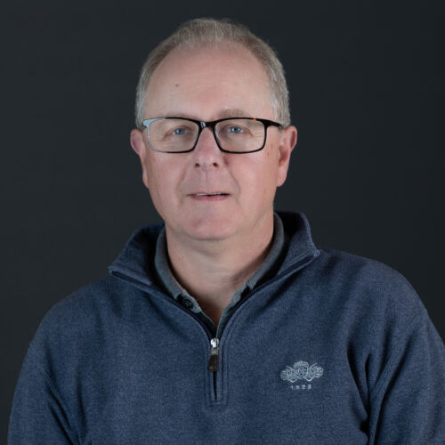 headshot of ian necus
