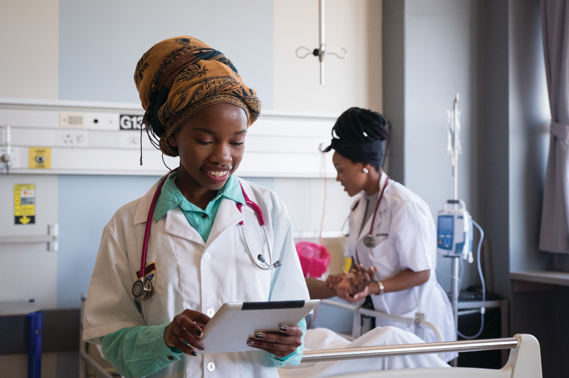 two young african doctors with a patient