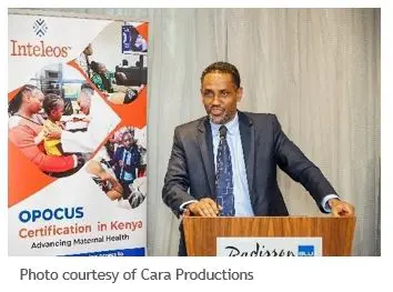 Dr. Mohamed Sheikh giving a speech at a podium